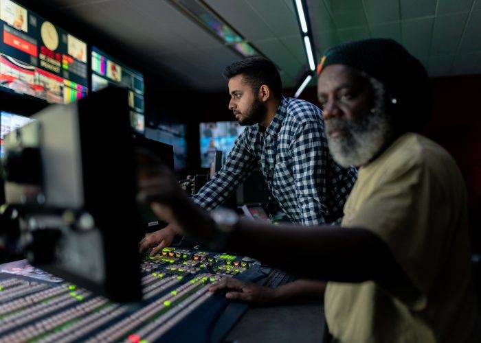 Broadcast engineers work in studio